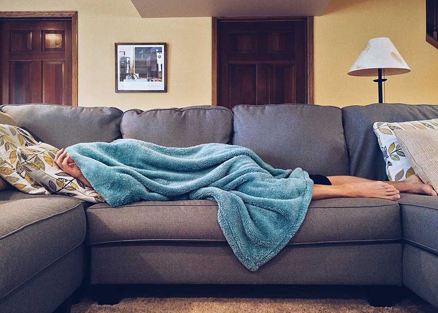 Tired person sleeping on the sofa
